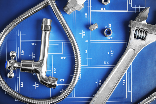 Faucet, hose and wrench on blueprint. 